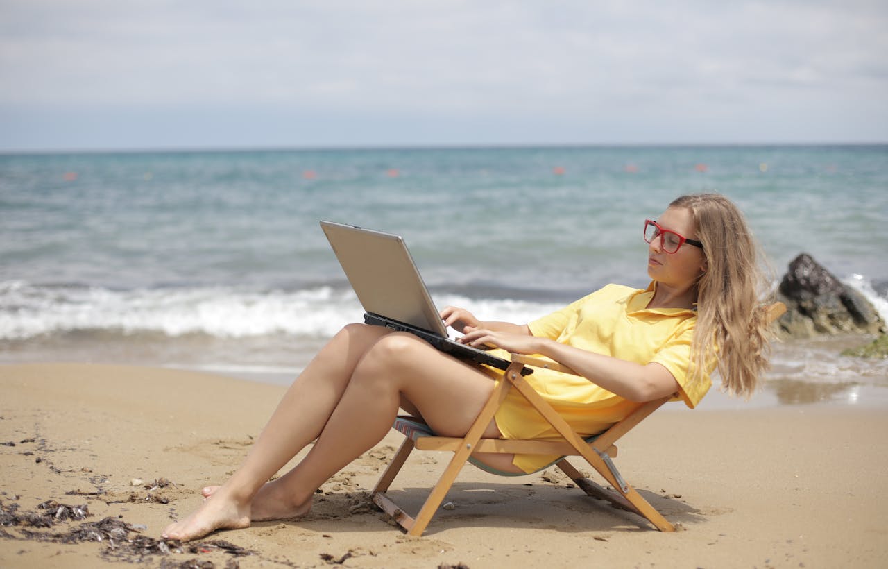 vrouw werkend op strand – Pexels